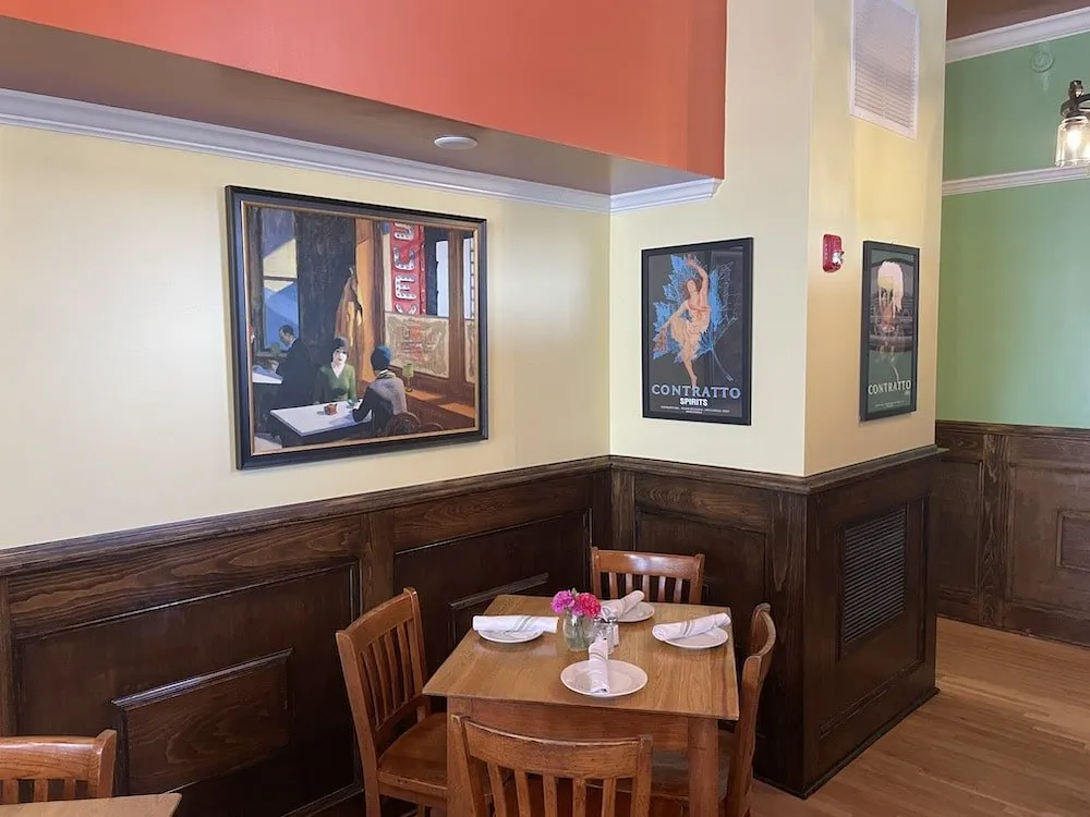 Italian dining corner with vintage artwork at Michael's Trattoria Wallingford CT